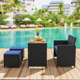 4 Piece Outdoor Dining Set with Wood Topped Dining Table  Rattan Loveseat Chair and 2 Ottomans-Navy